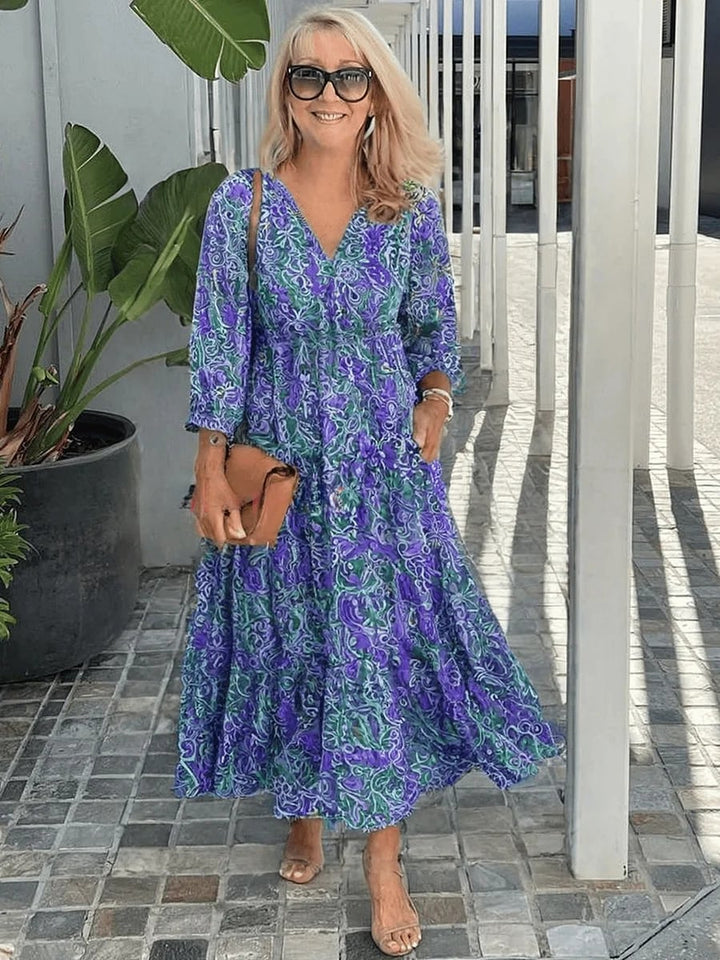 Flat lay of a casual floral boho dress in blue showing full length and relaxed fit