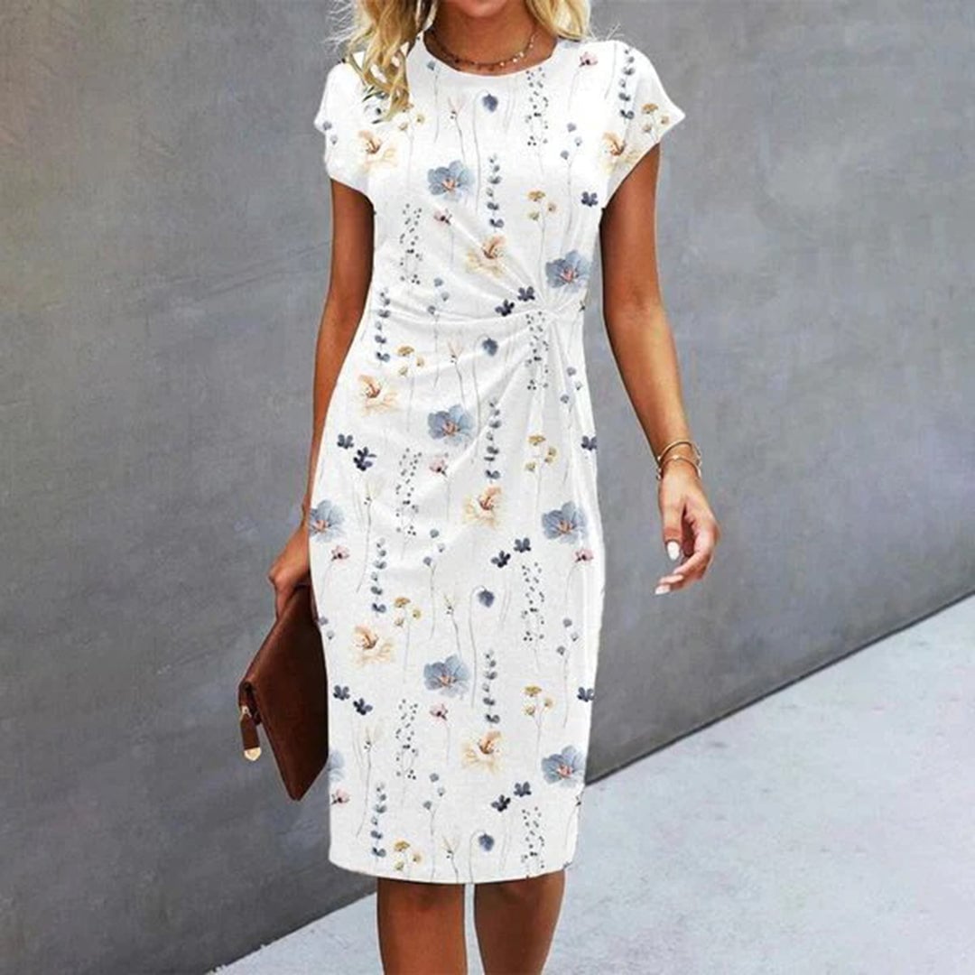 Woman wearing the Ivy white floral midi dress with a ruched waist and short cap sleeves, styled for a spring occasion
