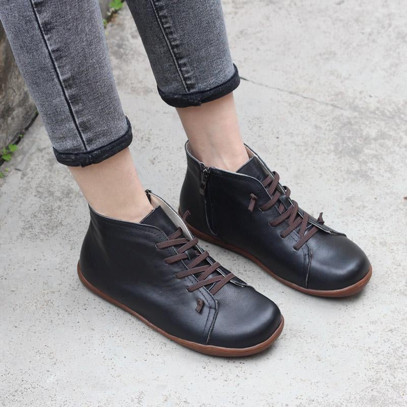 Close-up of Ivy zip boots in black highlighting the smooth zip and sole detail