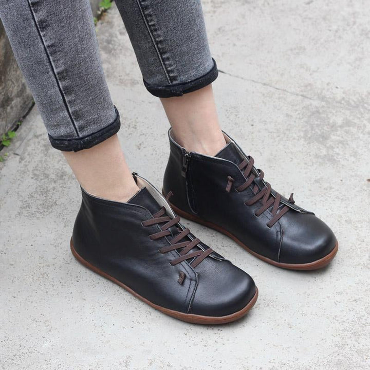 Close-up of Ivy zip boots in black highlighting the smooth zip and sole detail