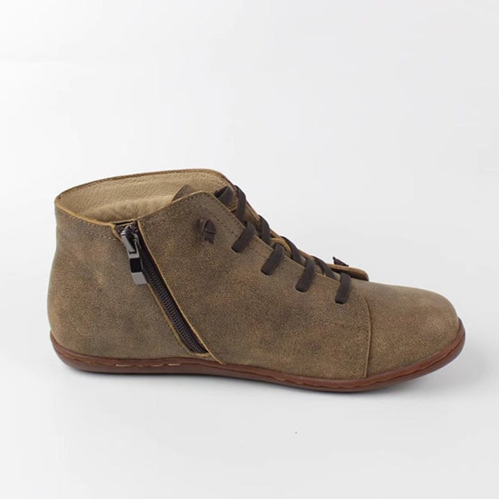 Close-up of Ivy zip boots in brown showing material texture and zip hardware