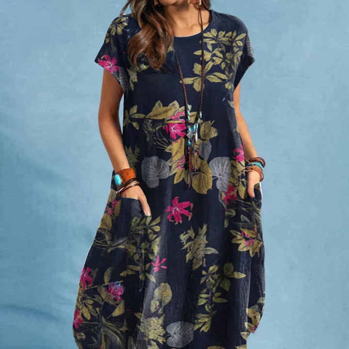 Woman wearing the Jackie dress in navy blue, showing the full-length flattering silhouette