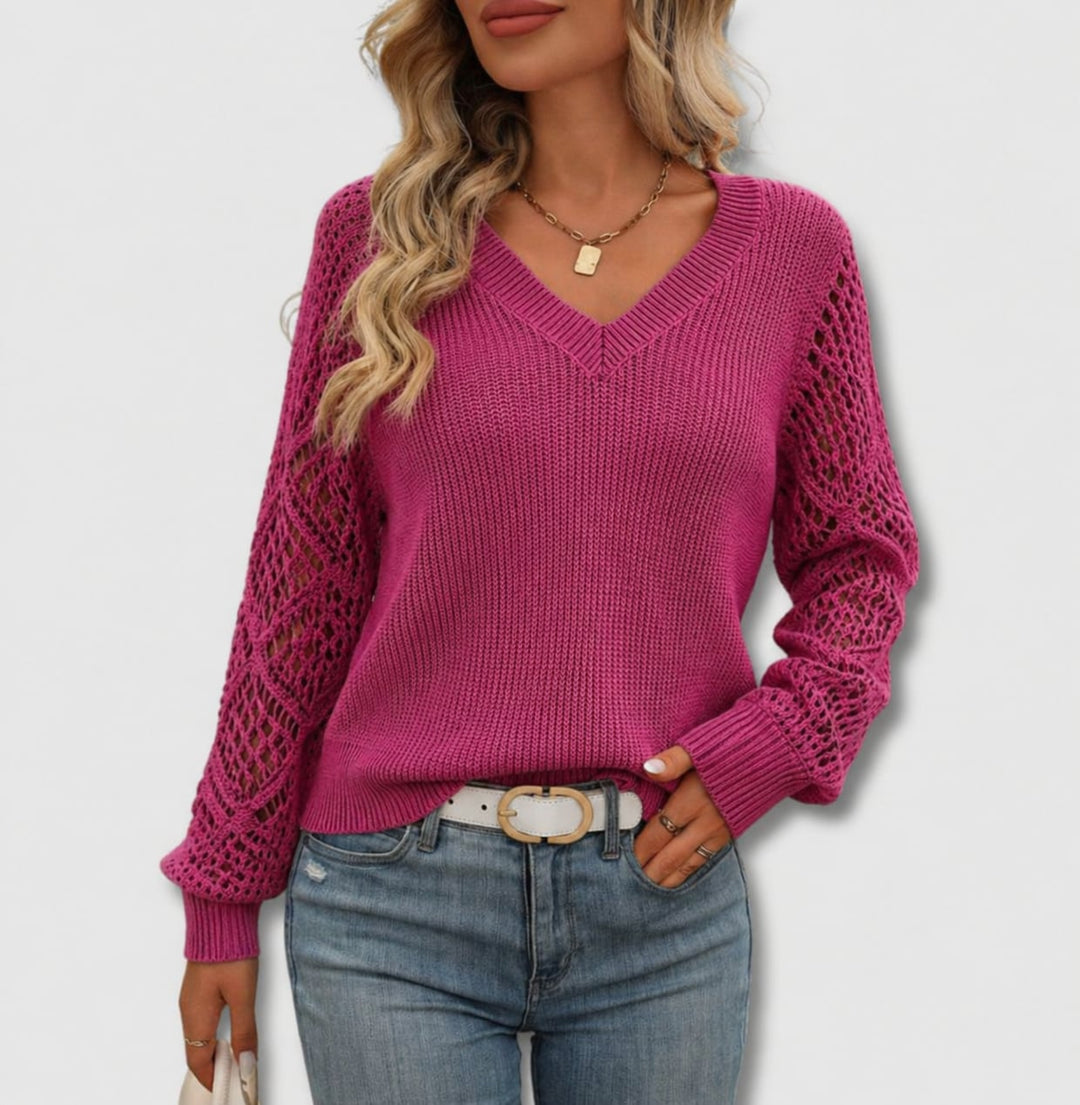 Woman wearing a soft pink elegant V-neck sweater with a flattering neckline and refined silhouette