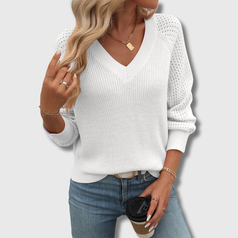 Close-up of a white V-neck sweater showing soft breathable fabric texture and elegant fit