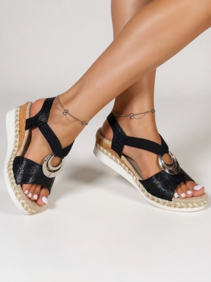 Close-up of crest-inspired detailing on Jade women's sandals in beige