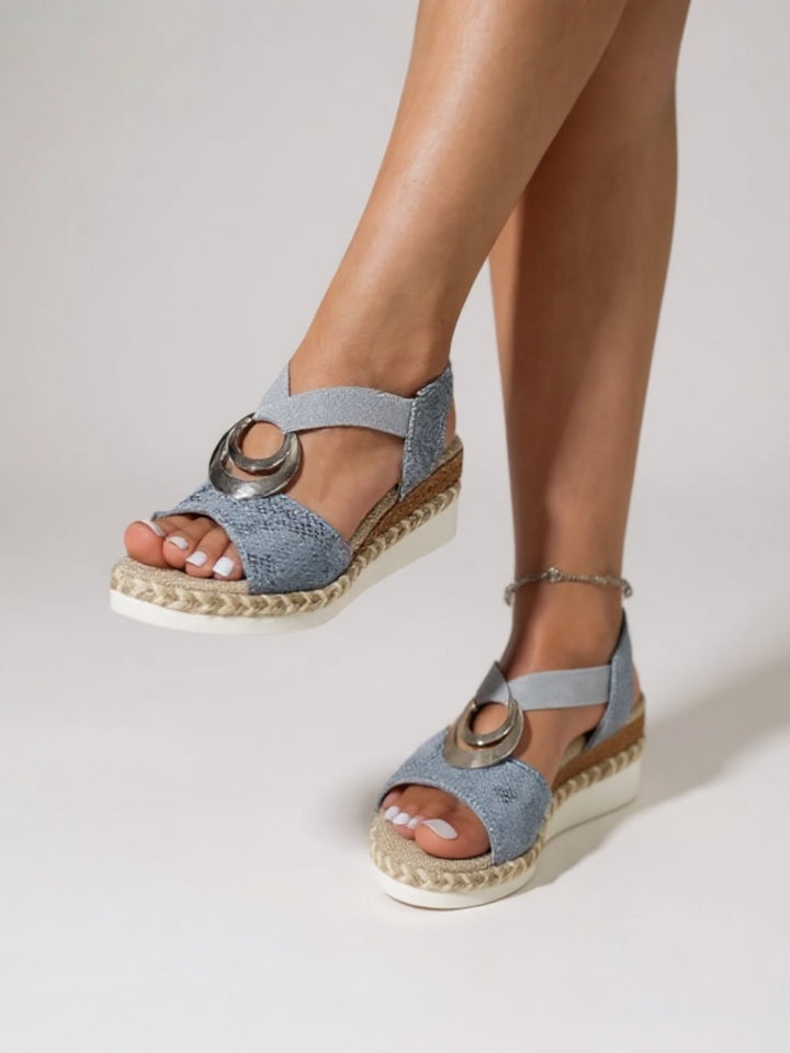 Jade cushioned sandals in blue worn on feet, styled with a floral sundress