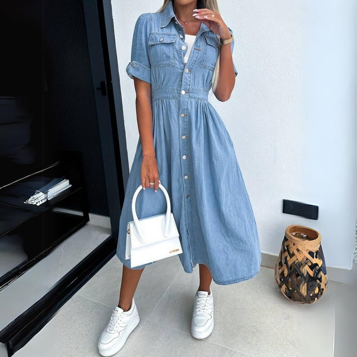 Front view of the Jade blue denim button-up midi dress with cinched waist and short puff sleeves