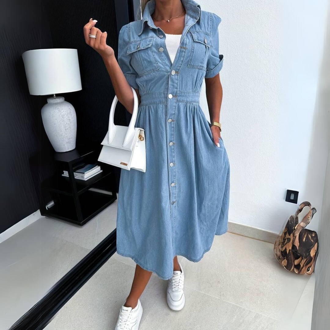Side view of the Jade denim midi dress showing the flowing A-line skirt and gathered waist detail