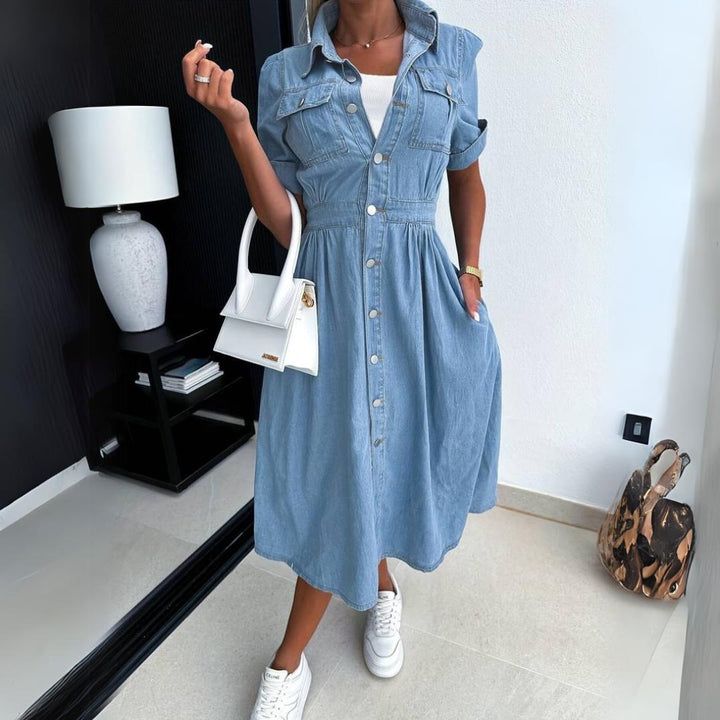 Side view of the Jade denim midi dress showing the flowing A-line skirt and gathered waist detail