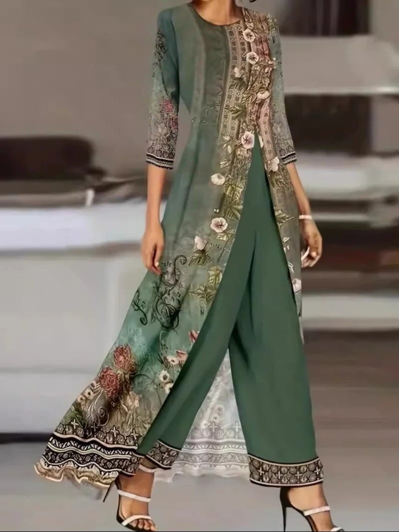 Forest green floral print two-piece set featuring a long botanical overlay top and matching solid wide-leg pants, shown on a model