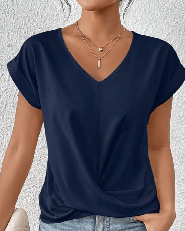 Close-up of the twist knot hem detail on a green V-neck short sleeve top