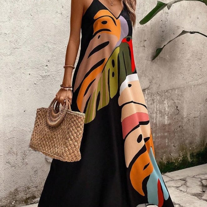 Woman wearing a vibrant multicolor leaf print maxi dress with a flowing silhouette, front view