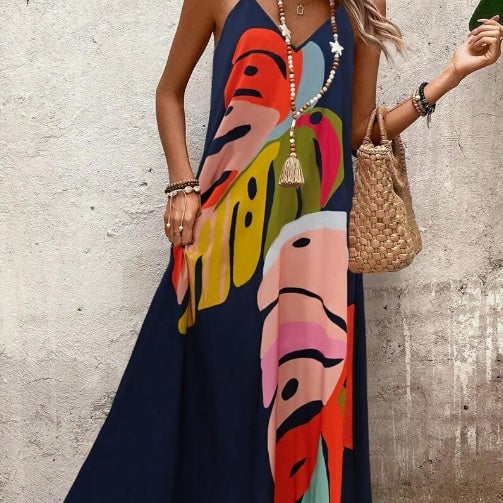 Close-up of the tropical leaf print fabric detail on a lightweight summer maxi dress in multicolor