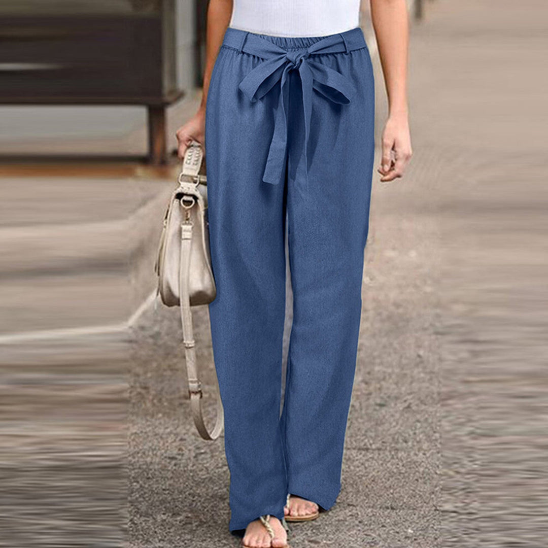 Jane wide-leg pants styled with a tucked-in blouse and flat sandals
