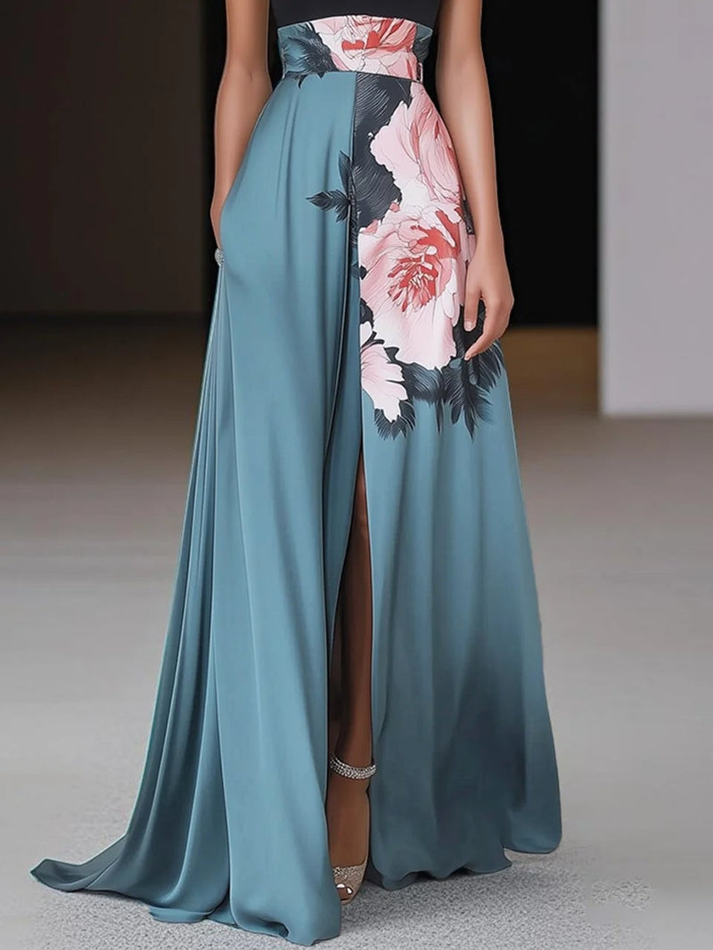 Back view of a woman in a black floral A-line maxi dress showing the flowing silhouette
