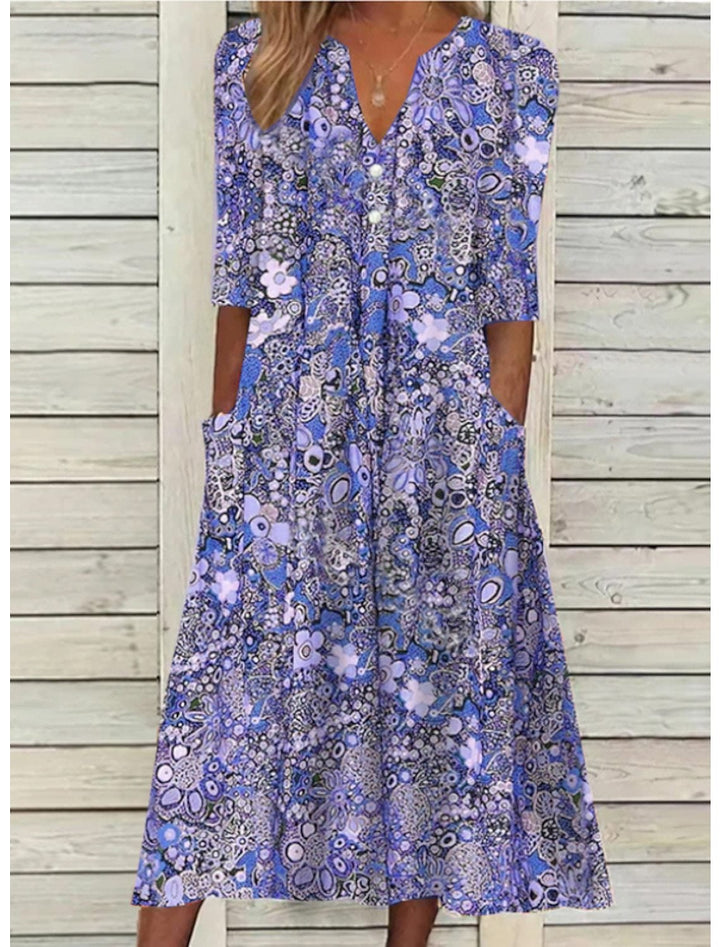 Close-up of the elegant V-neckline and lightweight fabric of the Florimay Janice summer dress in blue purple