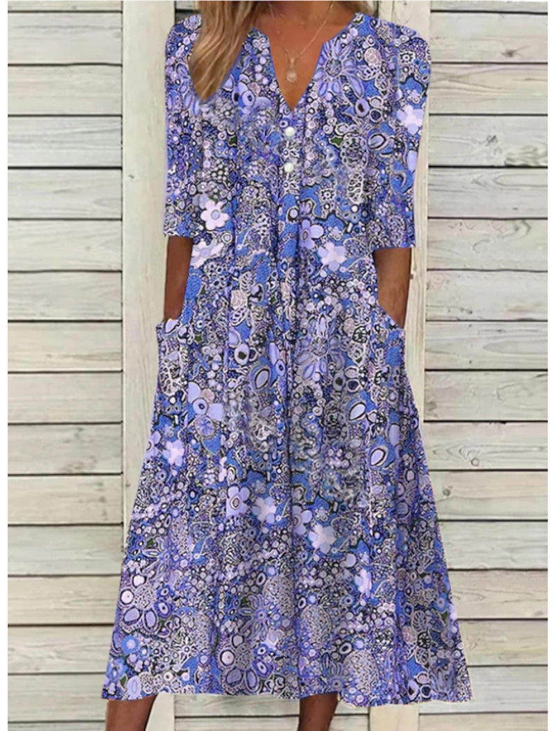 Close-up of the elegant V-neckline and lightweight fabric of the Florimay Janice summer dress in blue purple