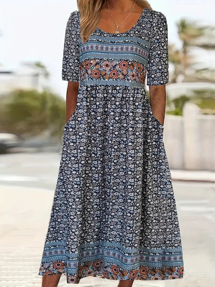 Close-up detail of bohemian multicolor print and round neckline on flowing dress