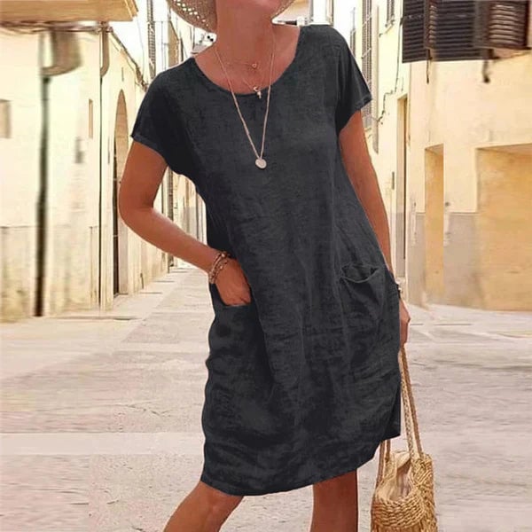 Woman wearing the Jasmine flowy draped tummy control dress in black, showing full-length silhouette and elegant draping