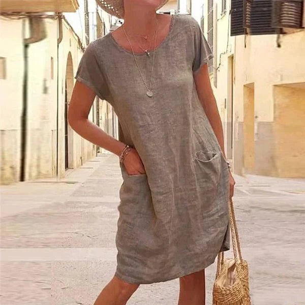 Close-up detail of the Jasmine draped dress in khaki showing soft fabric texture and tummy control fold design