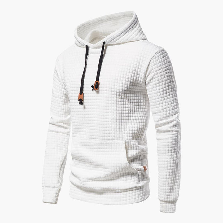 Woman wearing a white checkered comfort hoodie with a snug hood, styled casually