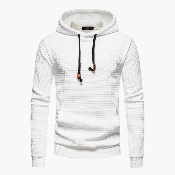 Model wearing the white Jasper Comfort Hoodie paired with light wash jeans