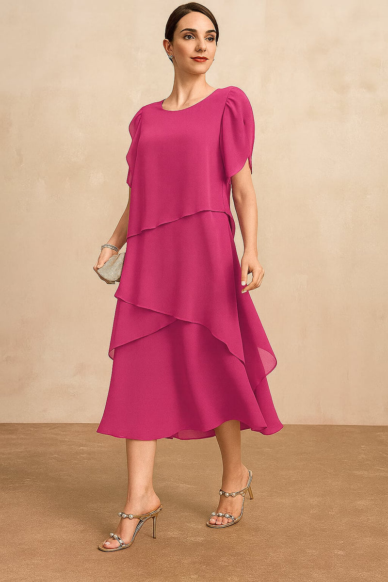 Model wearing a flowing pink chiffon dress with a classic flattering silhouette