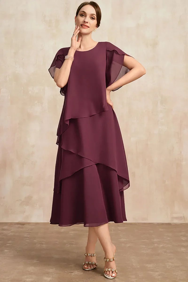 Front view of a lightweight brown chiffon dress with fluid fabric movement
