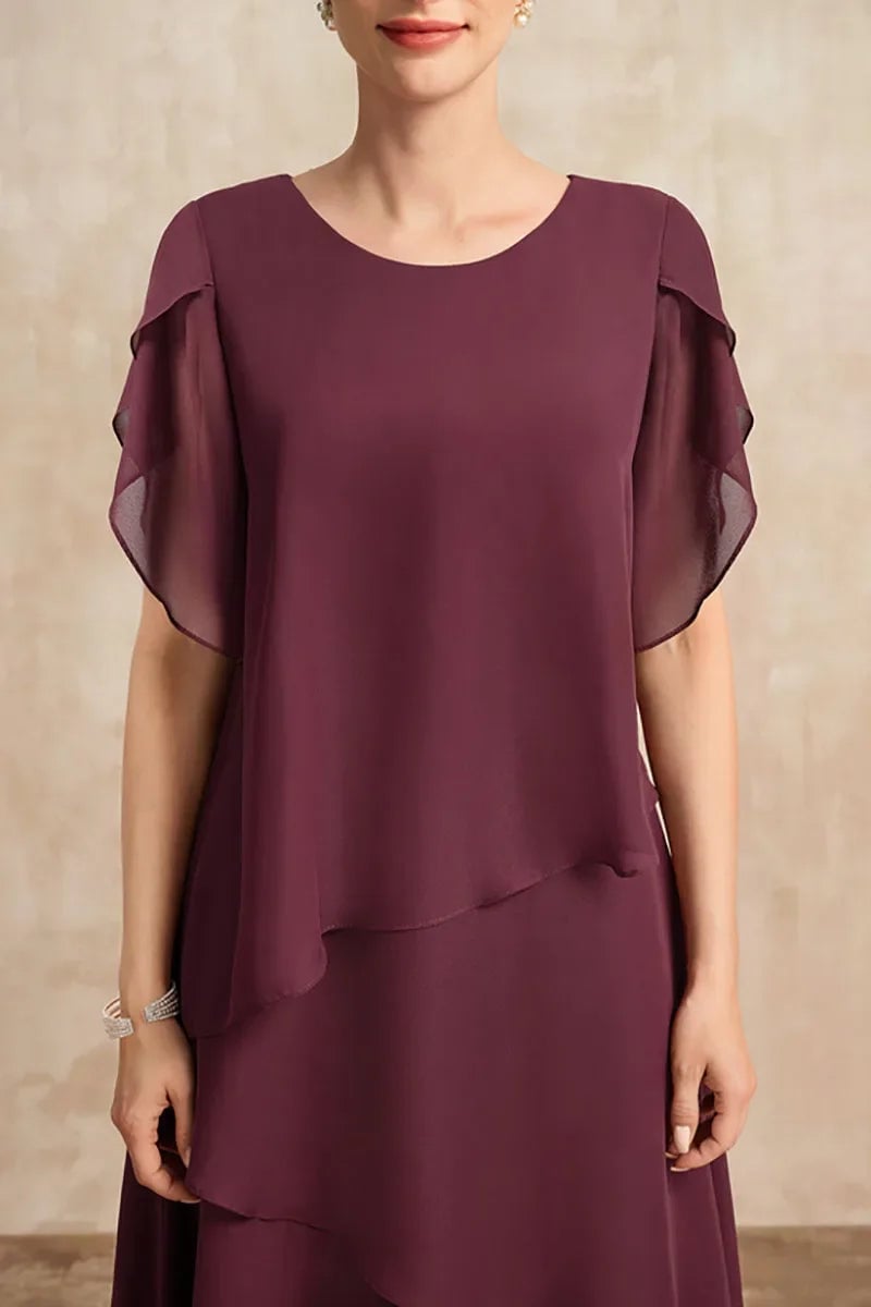 Full-length view of the brown chiffon dress highlighting its timeless cut