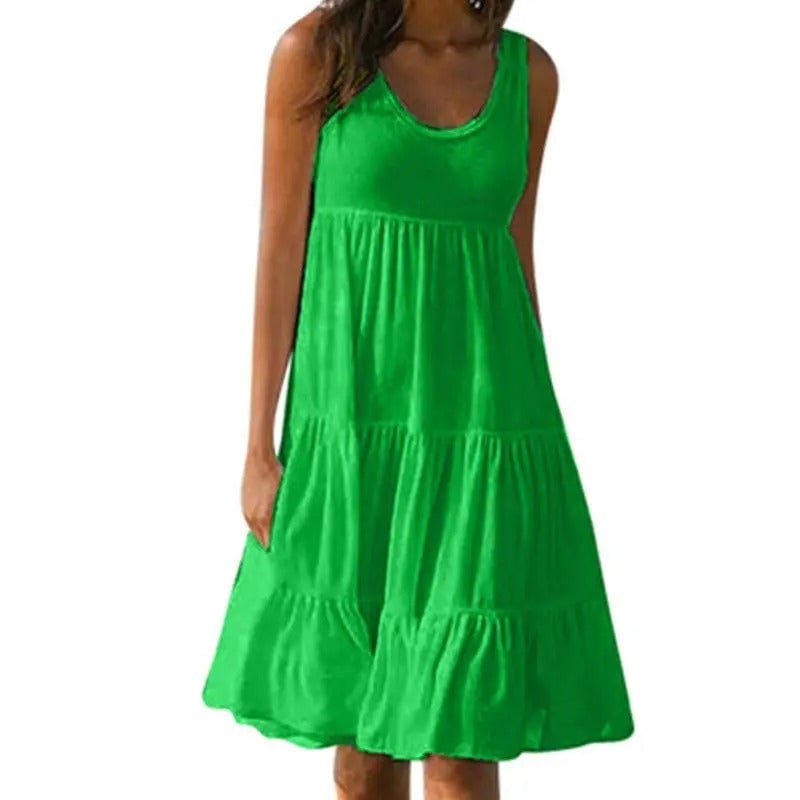 Woman wearing a green sleeveless solid bodycon dress with an open back and subtle hem split