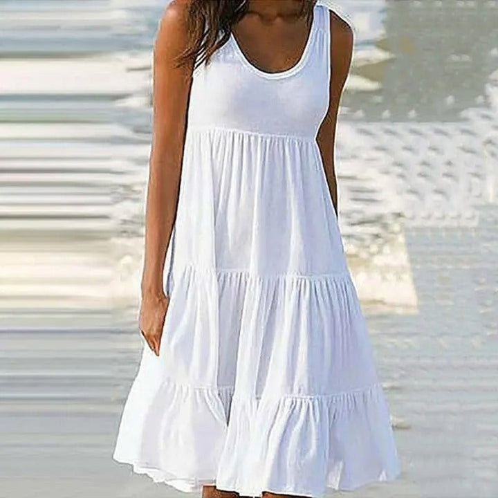 White sleeveless bodycon dress with open back worn for an evening occasion