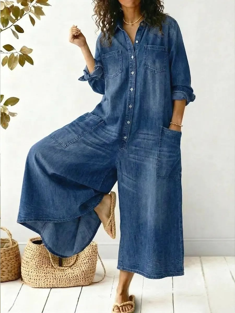 Woman wearing a blue wide-leg long sleeve button-front jumpsuit with patch pockets and a medium-wash finish
