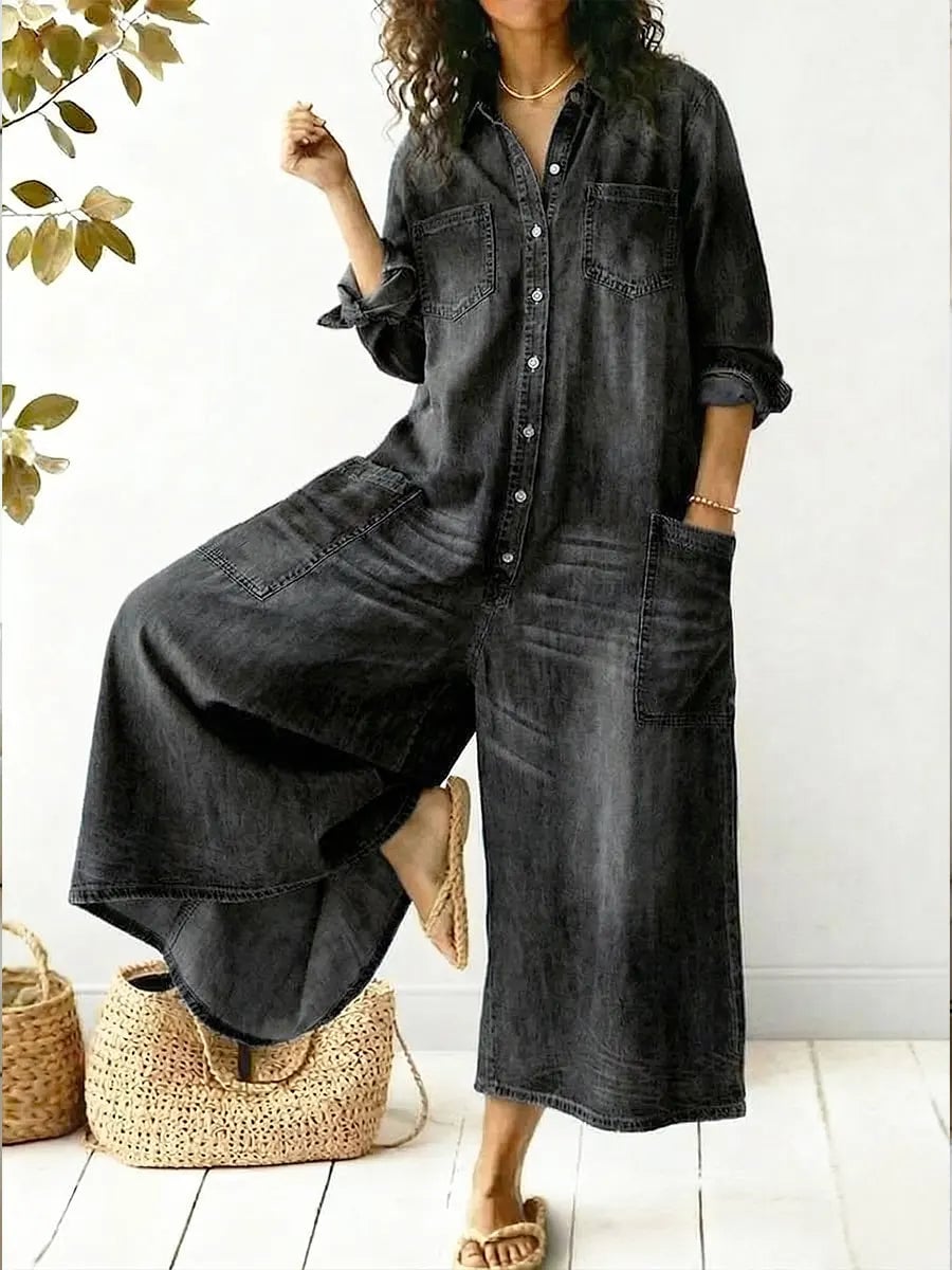 Front detail of the Jeen jumpsuit showing the point collar, button-front placket, and dual chest pockets in blue