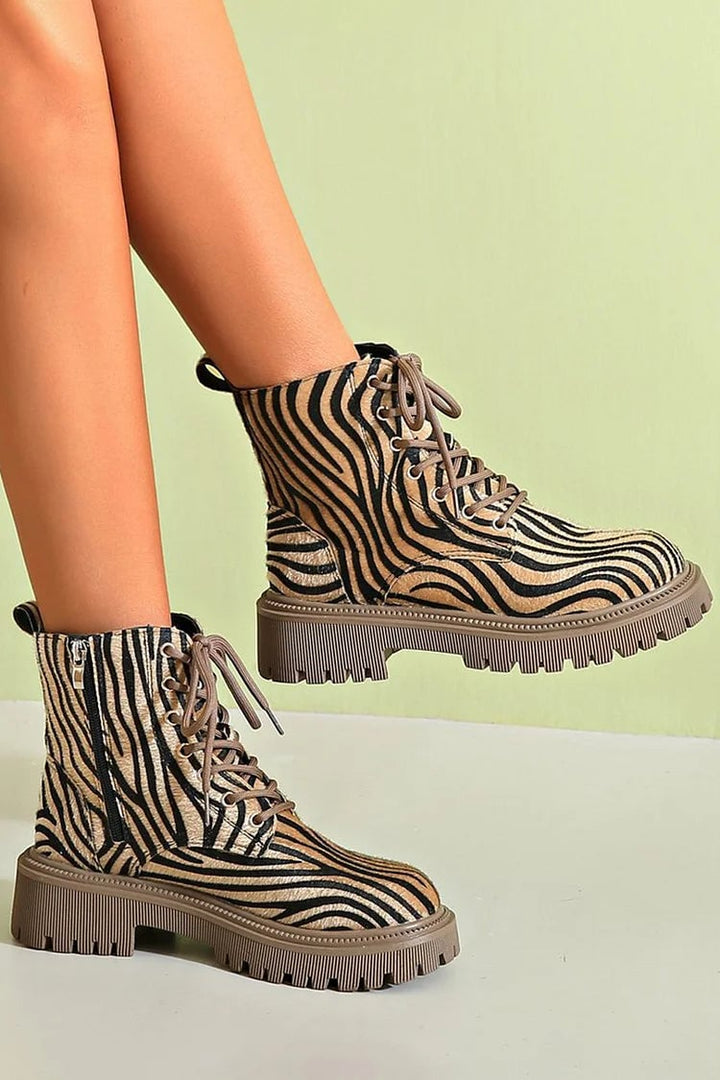 Side view of khaki zebra lace-up boots highlighting the sleek silhouette and adjustable lace-up closure