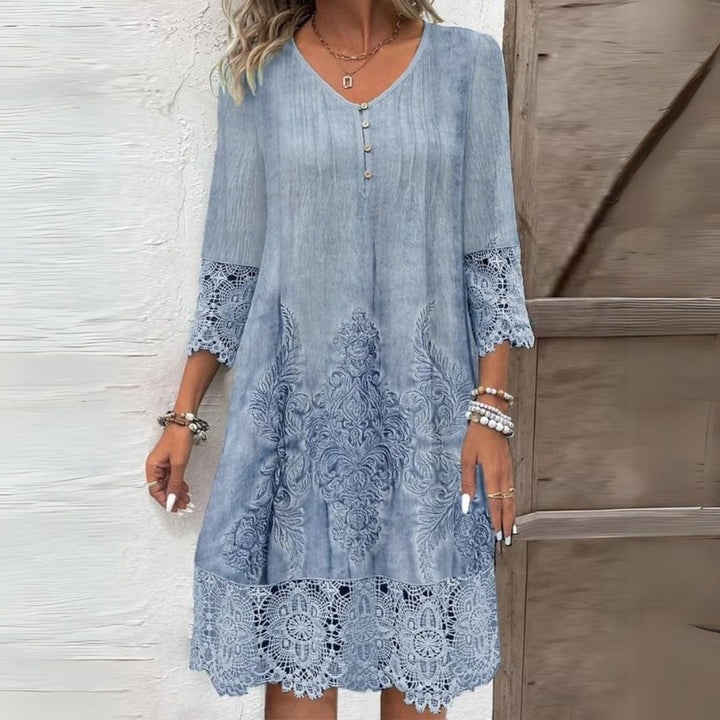 Woman wearing a blue floral embroidered midi dress with a relaxed, flattering fit