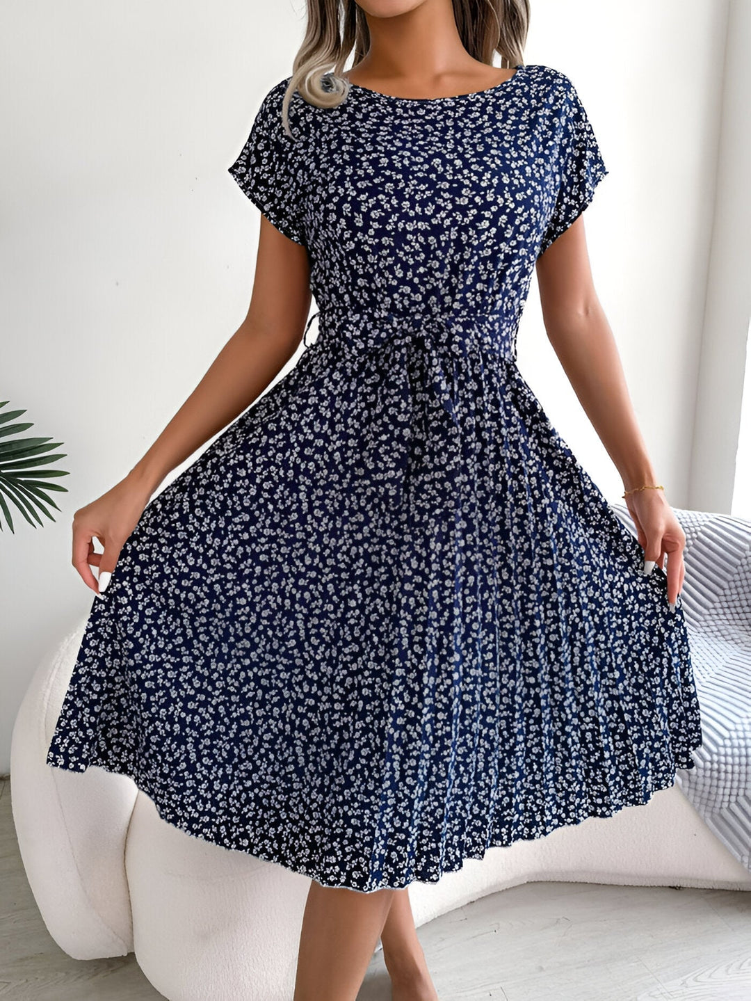 Back view of the floral pleated A-line dress in Navy Blue highlighting the elegant A-line cut