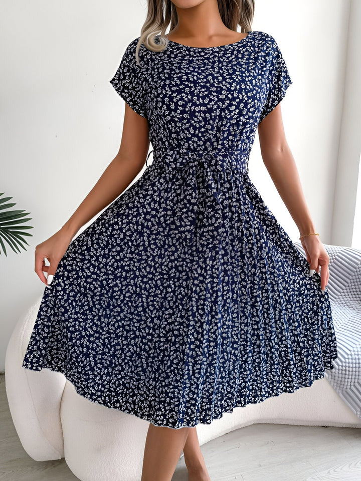 Back view of the floral pleated A-line dress in Navy Blue highlighting the elegant A-line cut