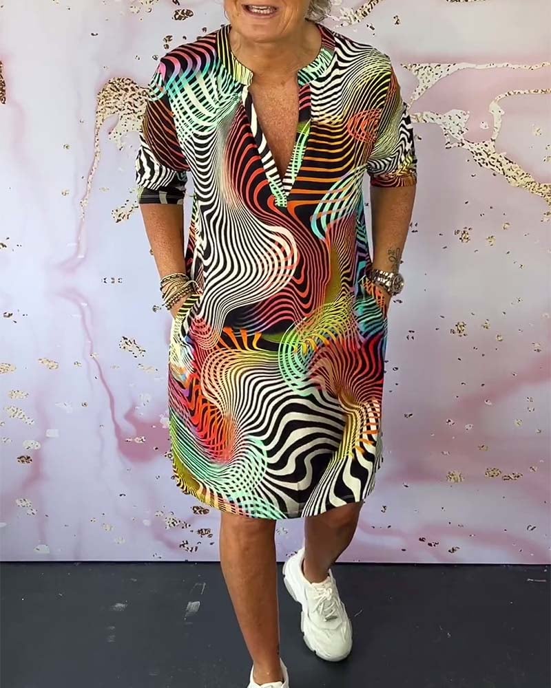 Model wearing a colorful V-neck dress in a multicolor print, front view