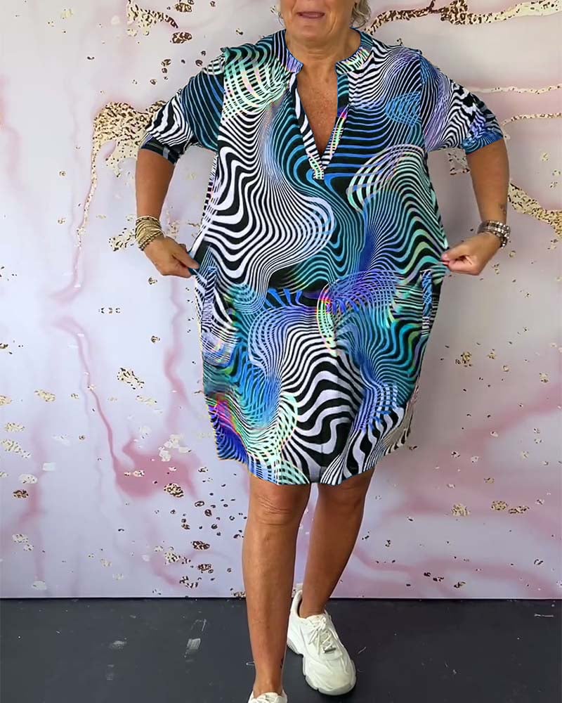 Model twirling in a multicolor V-neck dress showing the breezy, lightweight fabric