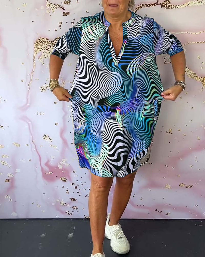 Model twirling in a multicolor V-neck dress showing the breezy, lightweight fabric