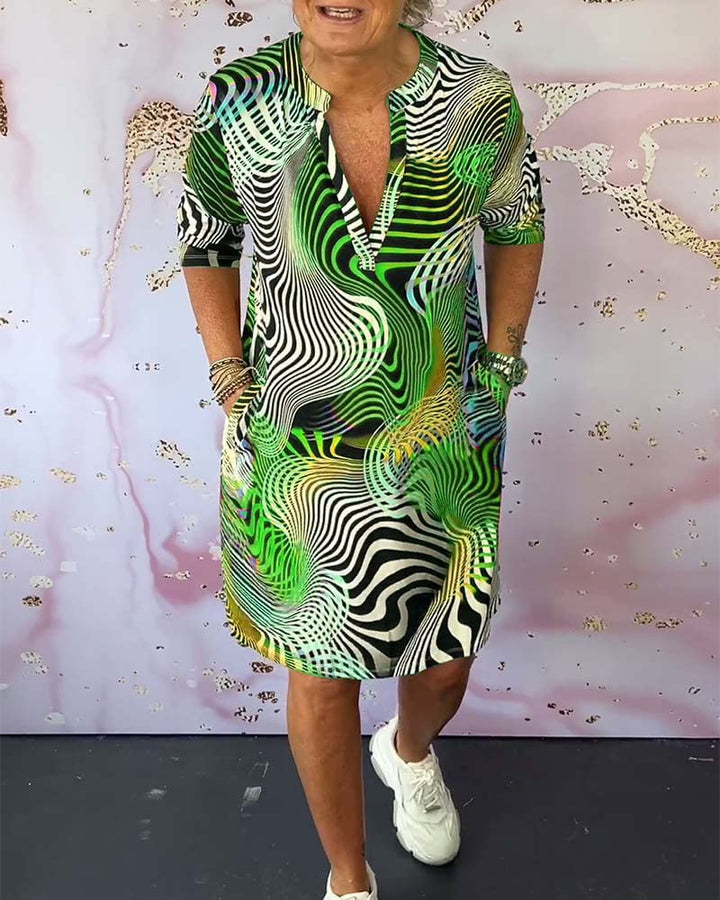 Side profile of model wearing a colorful V-neck dress highlighting the flattering fit