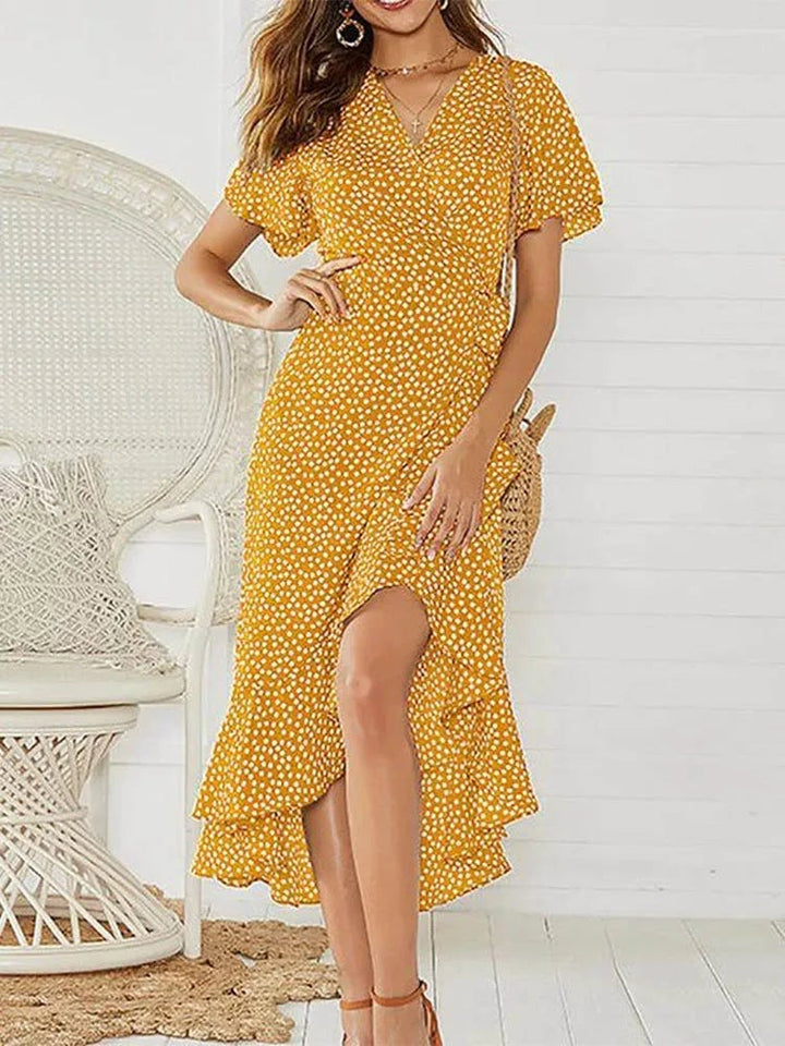 Close-up of ruffle neckline and floral print on a lightweight summer maxi dress in yellow