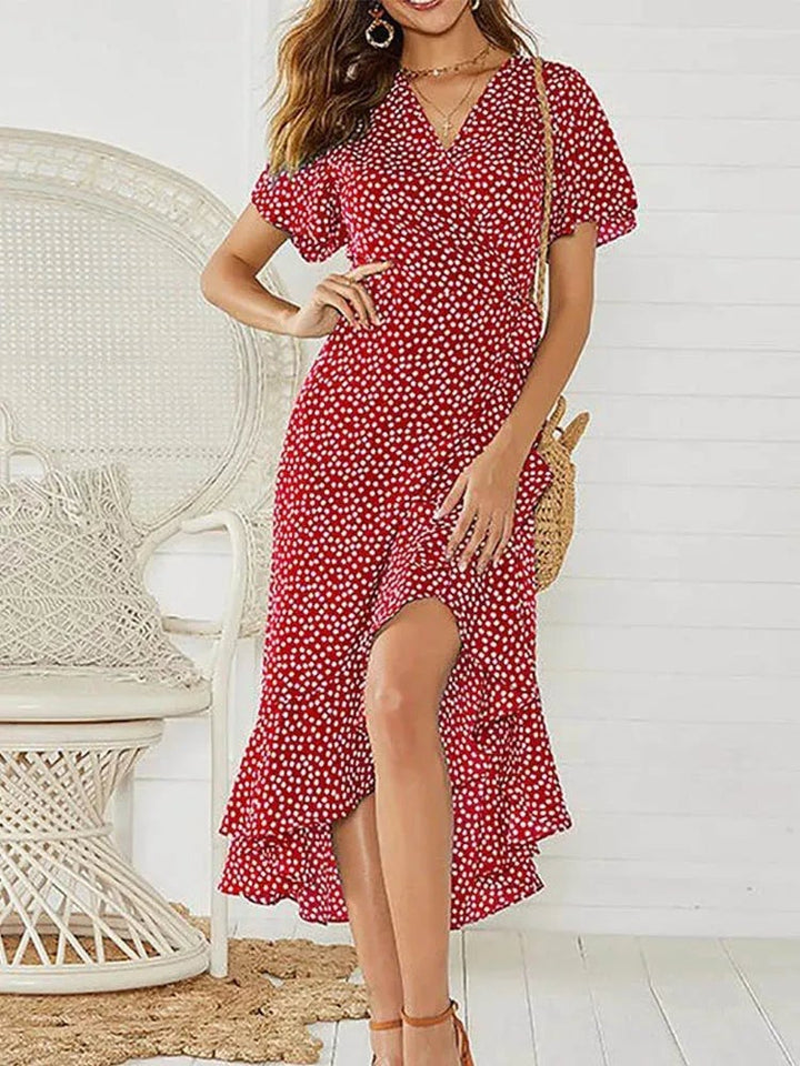 Flat lay of a floral maxi dress in multiple color options including green, white, yellow, black, and red