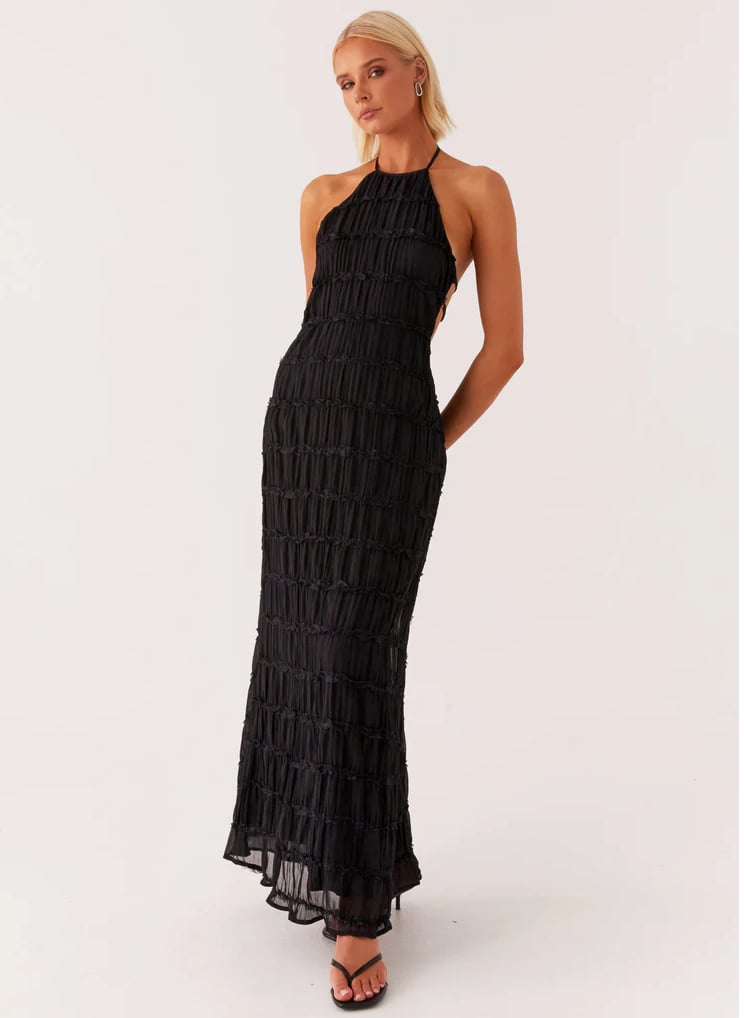 Full-length view of pink halter maxi dress on model showing graceful floor-length hemline