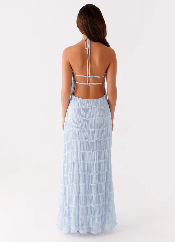 Flat lay of halter maxi dress in multiple color options including white, pink, blue, yellow, and black