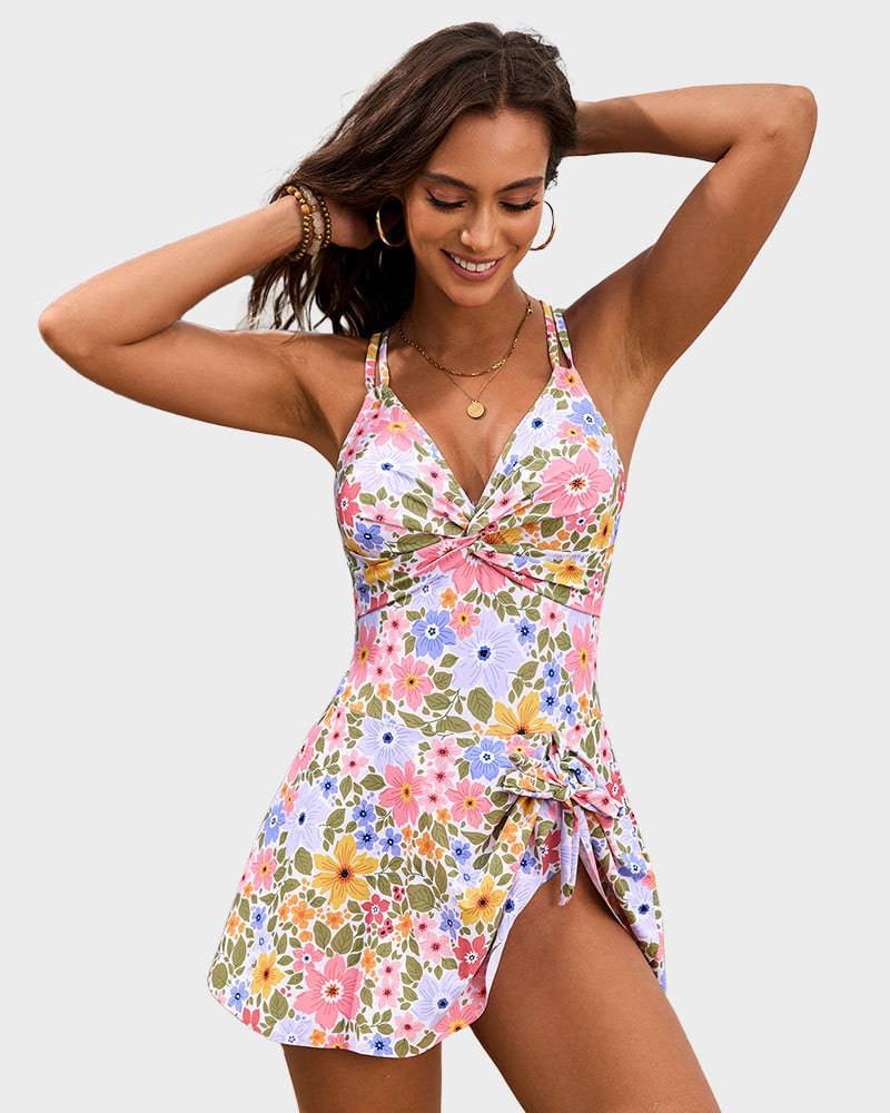 Front view of pink floral one-piece swim dress with feminine drape and tummy-smoothing design