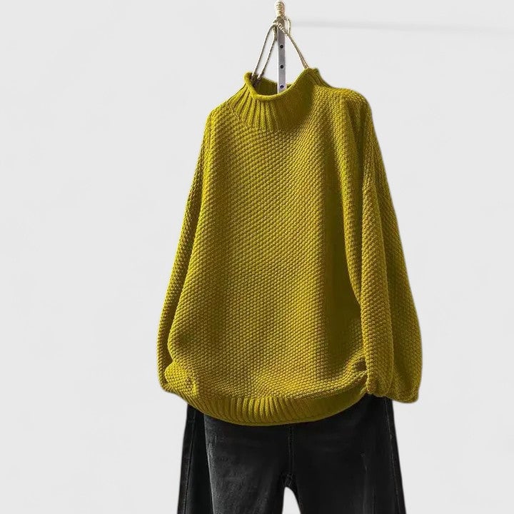 Model wearing the Jordyn sophisticated sweater in khaki styled with tailored trousers