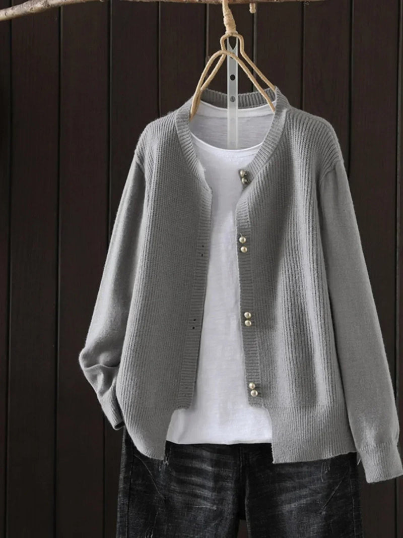 Woman wearing a soft, relaxed-fit Josephine cardigan in a neutral color, styled over a casual everyday outfit