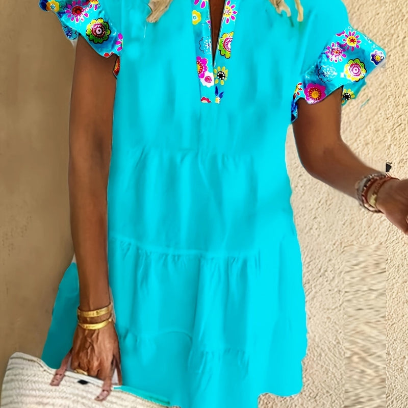 Woman wearing a blue boho flowy flare dress with a cinched waist and lightweight fabric, front view