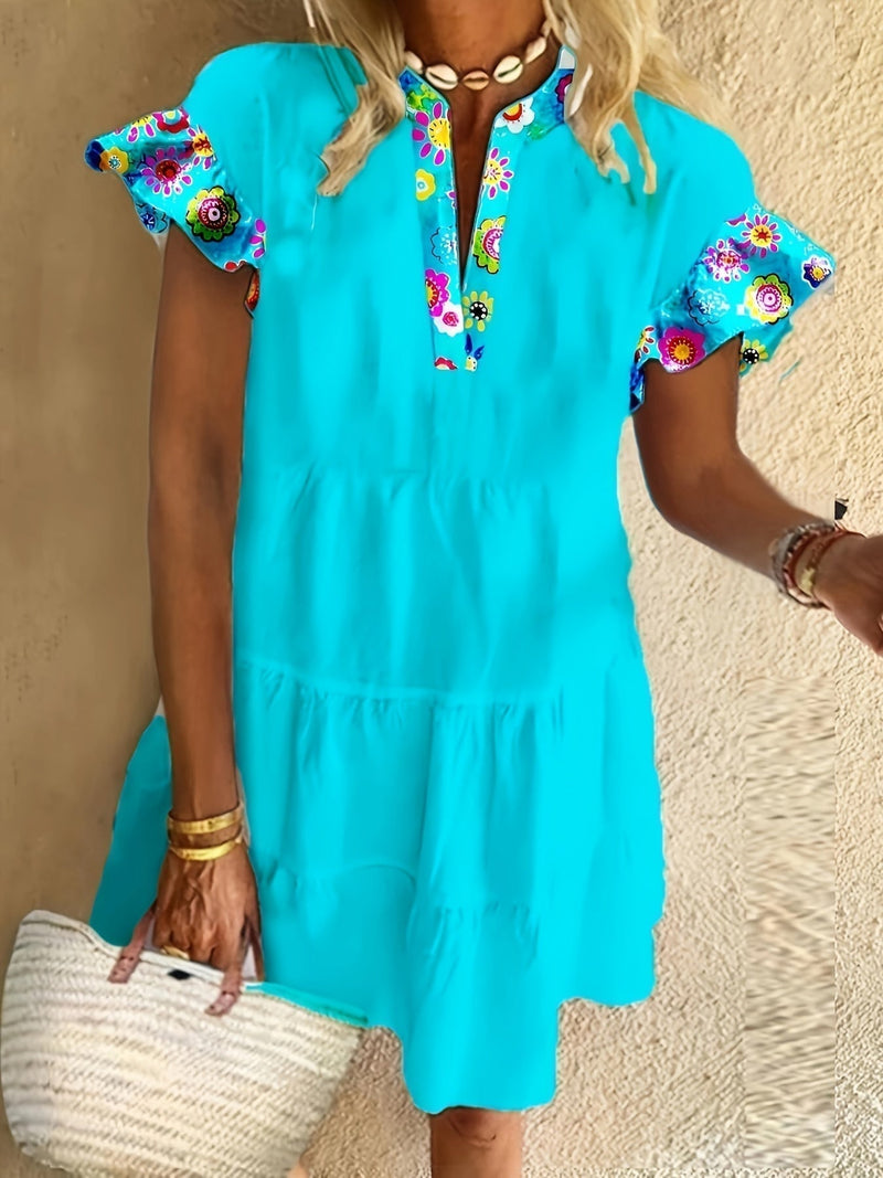 Close-up detail of the blue boho flowy dress showing its flowing silhouette and patterned fabric